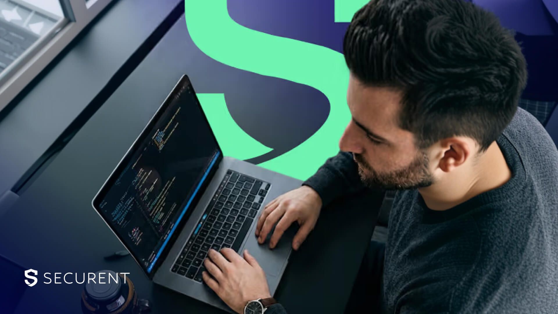 Top-down view of a man typing on a laptop with a terminal, behind him a dark purple wall with a green letter S and the Securent logo in the corner